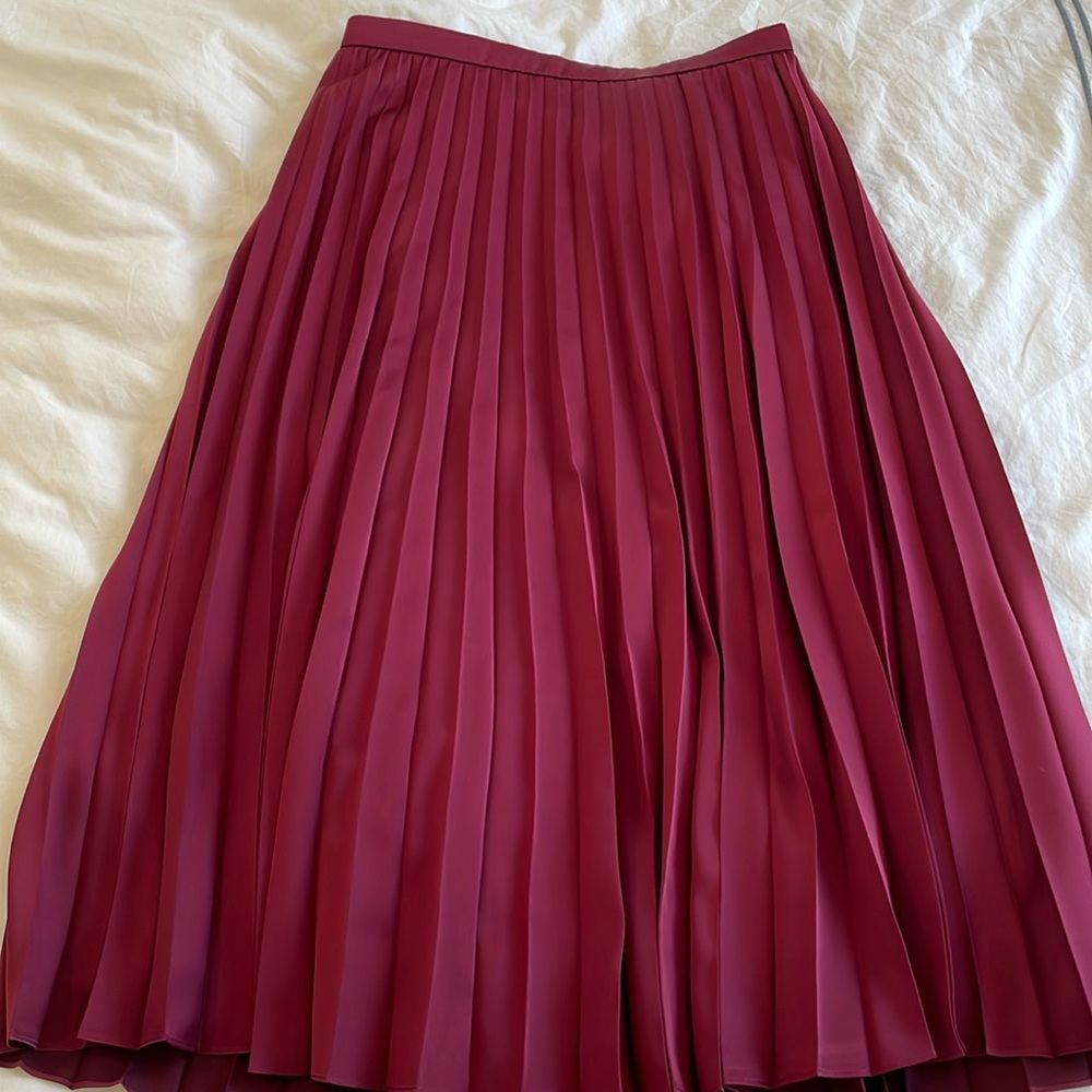 J. Crew cranberry pleated skirts.